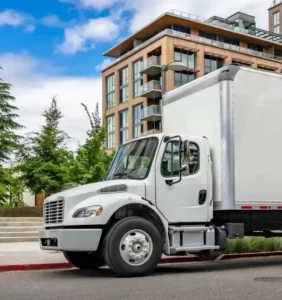 Box truck parked at a neighborhood curb representing local box truck dispatch operations