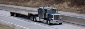 empty step deck trailer on a road