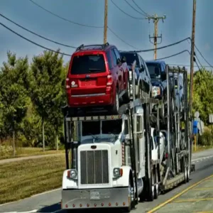 Car hauler truck on the road transporting consistent car hauler loads between clients
