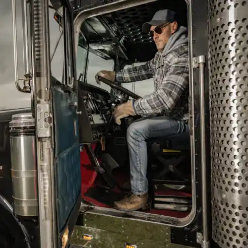 Dispatcher assisting driver with compliance paperwork amid rising trucking rates winter 2026